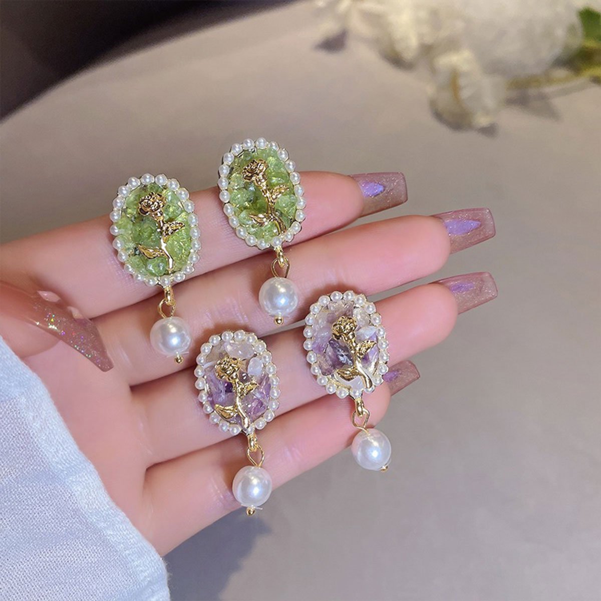 Vintage-inspired floral earrings with pearl drops.