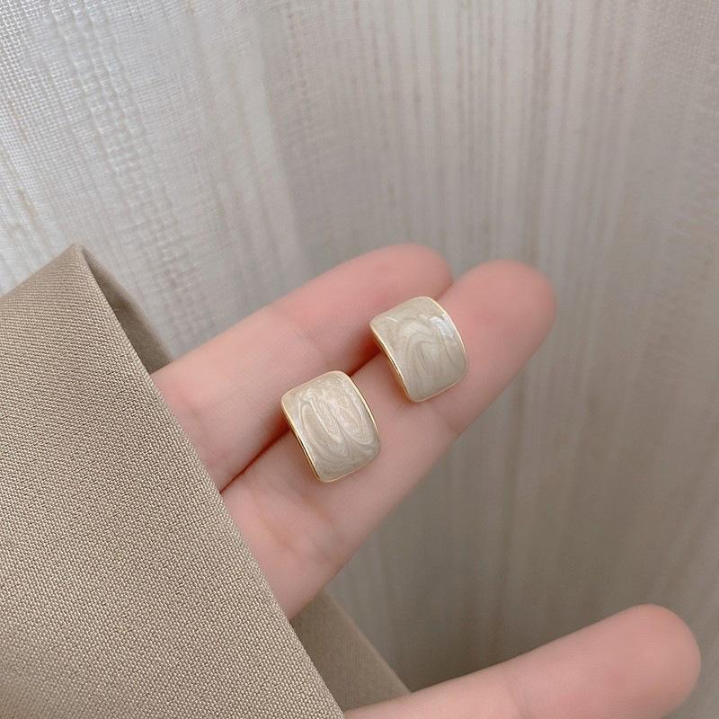 Elegant everyday earrings with ivory inlay and gold-tone frame